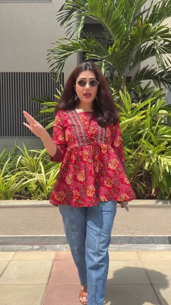 Women’s Floral Printed Peplum Top with Three-Quarter Sleeves, Front Tie Detailing, and Round Neck in Red and Blue Variants Paired with Stylish Blue Denim Jeans – Casual Ethnic Fusion Wear