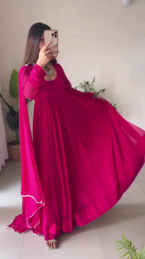 Elegant Pink Pleated Anarkali Dress with Sheer Dupatta, Traditional Silver Jewelry, and Contemporary Footwear for Festive and Special Occasions